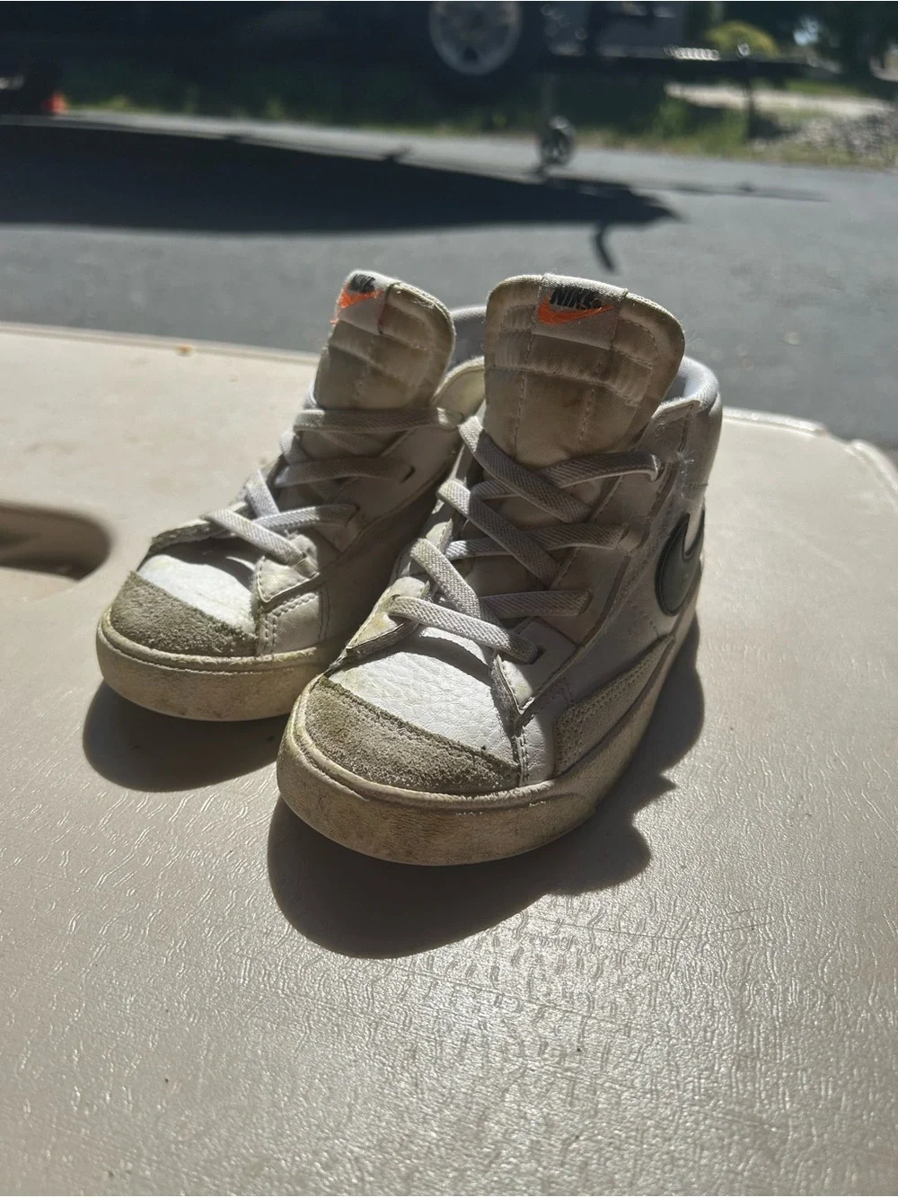 Nike Kids White High-Top Sneakers with Black Swoosh and Orange Tongue Accent